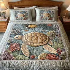 a bed with a sea turtle quilt on it's cover and two night stands