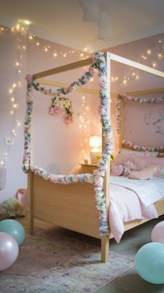 a pink bedroom with balloons and lights on the ceiling, bed frame is made from wood