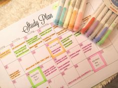 several markers are placed on top of a calendar with the word study plan written in it