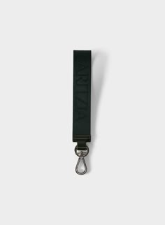 a black lanyard strap with the word lanyard on it, hanging from a hook