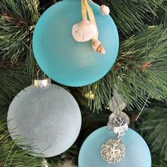 three ornaments hanging from a christmas tree