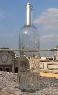 a glass bottle filled with water sitting on top of a roof