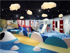 an indoor play area with slides and water features