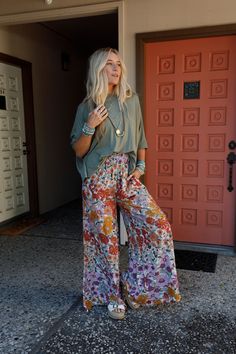 Elevate your boho wardrobe with the Blissful Burst Floral Pants - with their trendy wide legs and comfortable fit, you'll feel stylish and confident in any setting! Boho fabric that drapes beautifully and adds a touch of texture Bold floral print for an eye-catching look Palazzo silhouette with flared wide legs for a relaxed and breezy feel Thick smocked elastic waistband for good fit Convenient side seam pockets Pair with: Sophie Crochet Lace Bralette, On The Go V Neck Ribbed Essential Tee and Bohemian Business Casual, Boho Loungewear, Boho Wardrobe, Boho Essentials, Bralette Outfit, Boho Outfit, Mom Fashion, Boho Fabric, Bold Floral Print