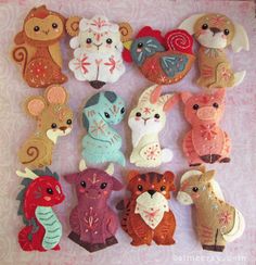 a group of small stuffed animals sitting on top of a pink table covered in fabric