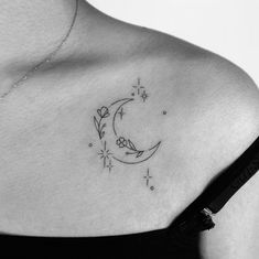 a black and white photo of a woman's shoulder with a tattoo on it