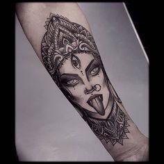 a woman's face on the arm with an ornate pattern in black and white