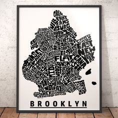 a black and white poster with the words brooklyn in different languages, on a wooden floor