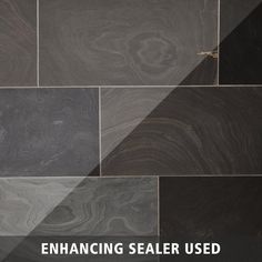 the words enhance sealer used are in front of an image of black and white marble tiles