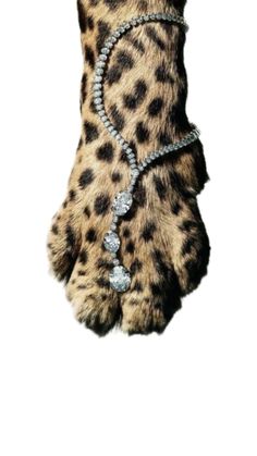 a leopard paw with some jewels on it's claws and the paws are made out of