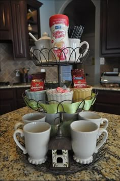 three cups are stacked on top of each other in front of the kitchen countertop