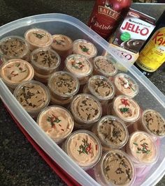 a plastic container filled with cupcakes on top of a counter next to other items