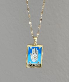 The "Fortune Tarot Card - 18K Pleated Stainless Steel Necklace" is likely a unique piece that merges jewelry with the mystical symbolism of tarot. Featuring an 18K gold plating over durable stainless steel, this necklace could showcase a design inspired by the Fortune card, representing luck, fate, and positive change. The pleated texture might add an artistic flair, enhancing its visual appeal. Such a necklace can serve as a meaningful accessory, reminding the wearer of the power of destiny and Tarot Elements, Fortune Tarot Card, Fortune Cards, Steel Necklace, Positive Change, Stainless Steel Necklace, Tarot Card, Water Proof, Heart Design