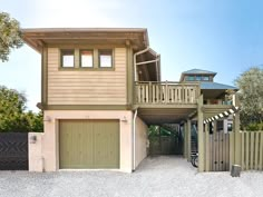 a two story house with an attached deck and garage on the second floor is shown