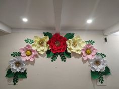 some paper flowers are hanging on the wall