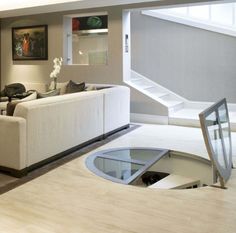 a living room filled with furniture and a staircase leading up to the second floor area