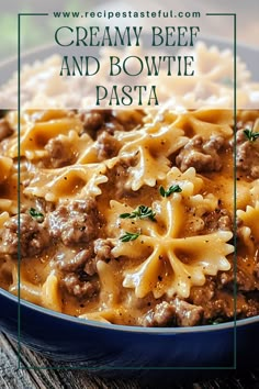 creamy beef and bowtie pasta in a blue bowl on a wooden table with text overlay