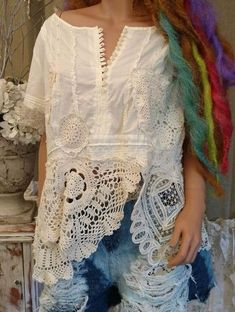 a mannequin is dressed in white with multicolored hair