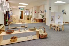 an empty room with tables and baskets on the floor