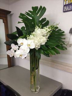 a vase filled with white flowers on top of a table