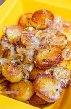 a yellow container filled with potatoes and onions