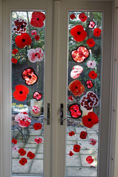 two glass doors decorated with red and white flowers