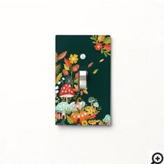 a light switch cover with flowers and mushrooms on it