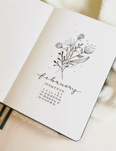 an open planner with flowers on it