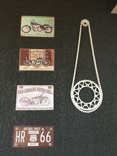 there are three different items hanging on the wall next to each other, including a motorcycle and license plate