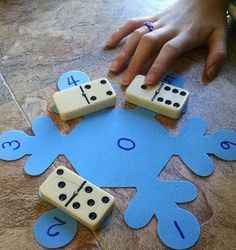 a child is playing with dominos on the floor