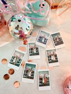 several polaroid photos are laying on the table with confetti and other decorations