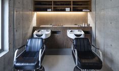 two black and white chairs sitting in front of a counter