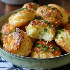 a bowl filled with potatoes covered in parmesan cheese