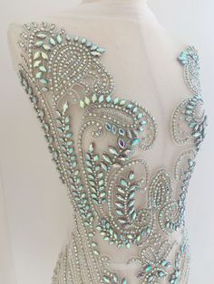 the back of a dress with beading on it