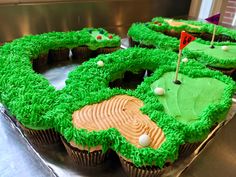 the cupcakes are decorated with green frosting and golf themed designs on them