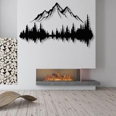 a living room with a fire place and mountains on the wall above it, in front of a fireplace