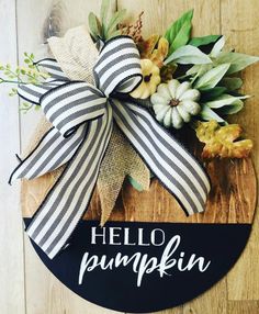 a wooden sign that says hello pumpkin with flowers and leaves around it on a wood surface