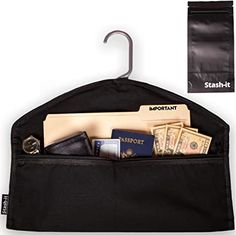 a black bag that has some money in it and an umbrella hanging on the wall