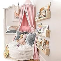 a child's bedroom with pink and white decor