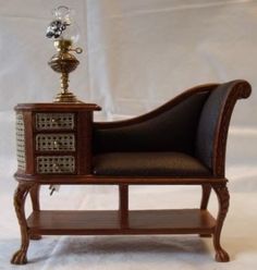 a miniature chair with a lamp on top of it and a shelf in the middle