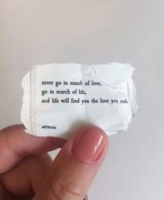 someone is holding up a piece of paper that says never go in search of love, go in search of life