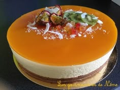 a cake with orange icing and toppings on top