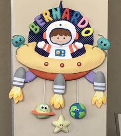 a child's room door decorated with an outer space theme and toys hanging from it