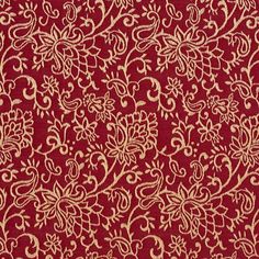 a red and gold fabric with white flowers on it