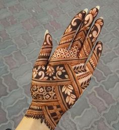 a person's hand with hennap on it, showing the intricate design