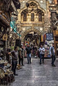 people are walking through an open market area