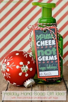 a bottle of holiday hand soap next to an ornament