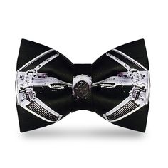 a close up of a bow tie with a watch on it's center piece