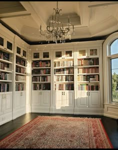 a room filled with lots of books and a chandelier