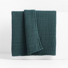 two green towels folded on top of each other